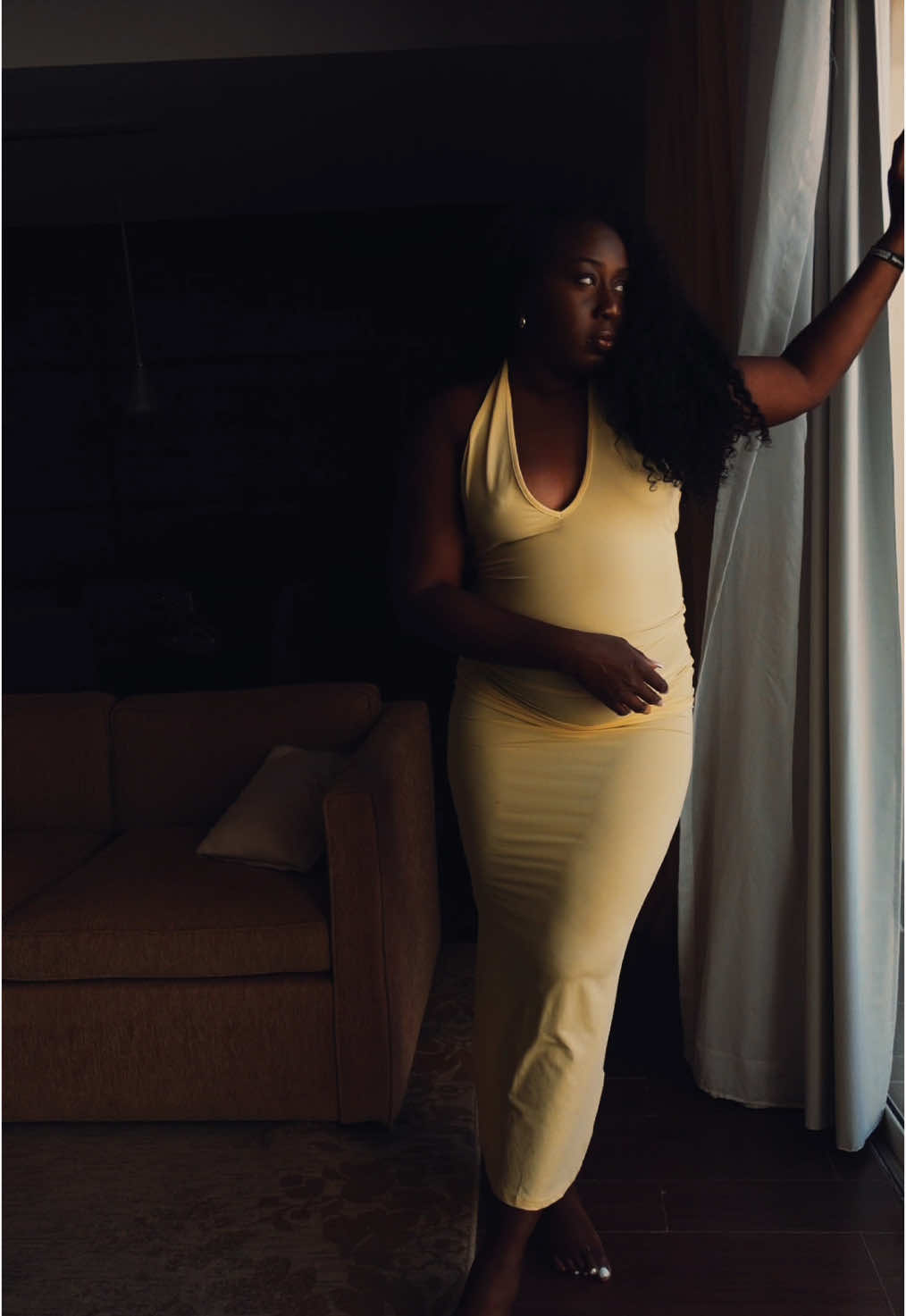 Marcelle Adrianna in a yellow dress in a TikTok OOTD video.